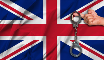 United Kingdom Flag with Male Hand Holding Handcuffs