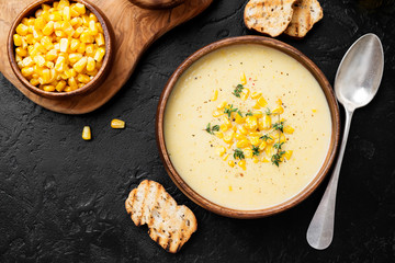 Delicious creamy sweetcorn soup served with toast and corn grains.