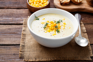Delicious creamy sweetcorn soup served with toast and corn grains.