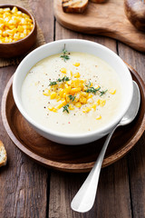 Delicious creamy sweetcorn soup served with toast and corn grains.