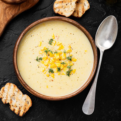 Delicious creamy sweetcorn soup served with toast and corn grains.