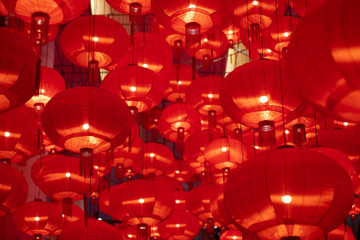 Traditional red lanterns decorated for Chinese new year Chunjie. Cultural festival in Shanghai. Bright Lush lava red background.