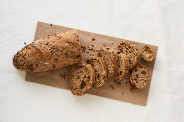 Slices of rye loaf with flax seeds on a light background