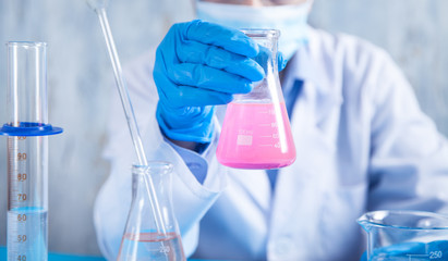 Girl working with flask in a laboratory.