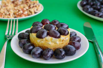 The legendary Tiffany layered salad with grapes, chicken and cheese on the green background.