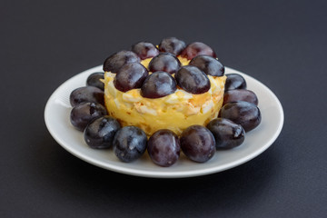 The legendary Tiffany layered salad with grapes, chicken and cheese on the black background.