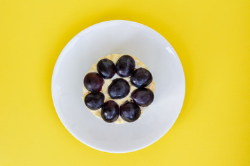 The legendary Tiffany layered salad with grapes, chicken and cheese on the yellow background.