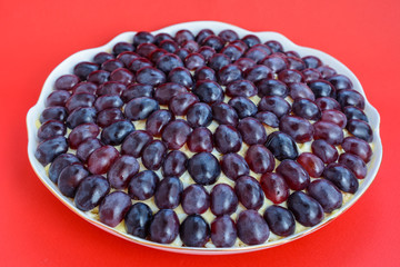 The legendary Tiffany layered salad with grapes, chicken and cheese on the red background.