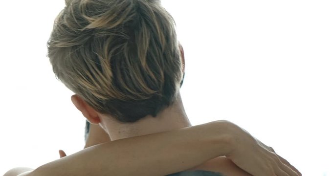 Close up of sexy lover kissing with white curtain in background. Caucasian male with his girlfriend in black mask, asian woman in black lingerie. Safe sex and bdsm roleplay concept.