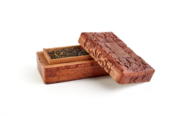 Wooden carved casket with tea on a white background