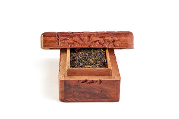 Wooden carved casket with tea on a white background