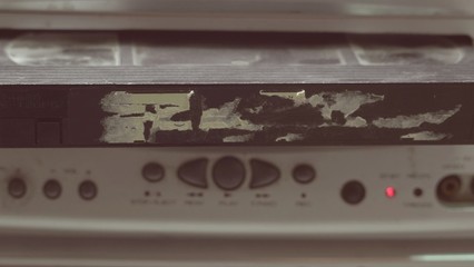 Old VHS Video Cassettes and Old Video Recorder. Closeup. videotape cassette inside vcr , old technology concept 