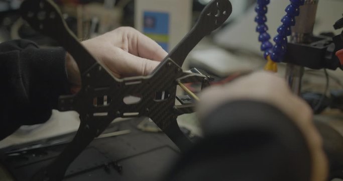 closeup of worker's hands assembling product in a Chinese factory.