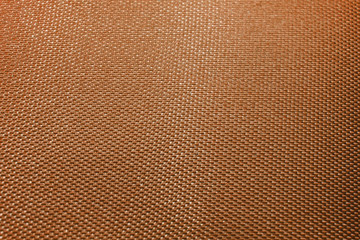 Close-up abstract flat orange high detail textured clothing fabric pattern background partial focus and realistic light