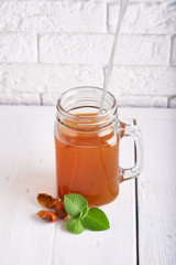 Homemade lemonade of dried fruits in a jar on a light table. Vertical Copy space