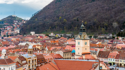 Fototapeta na wymiar Panoramic view of Brasov from White tower and Black tower in the evening during spring season . One of the most famous view points in the heart of Brasov , Transylvania , Romania
