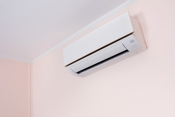 Fototapeta Wall mounted air conditioner in livingroom after cleaning and maintenance. obraz