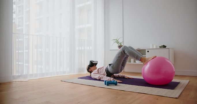 Young Caucasian woman fitness training with Virtual Reality set 