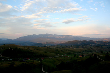 Very small mountain village with the peaks behind