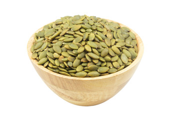 Pumpkin seeds in wooden bowl isolated on white	