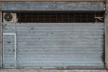 vintage store or shop with closed metal shutter  -