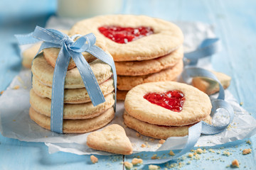 Milky valentine cookies with red strawberries jam