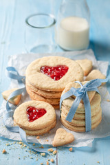 Obraz na płótnie Canvas Delicious valentine cookies with red strawberries jam