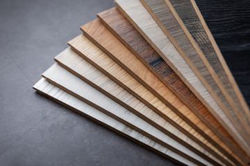 variety of laminate material samples on dark stone background
