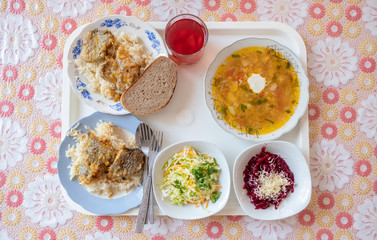 Top view at the tray with food in classic old times soviet canteen