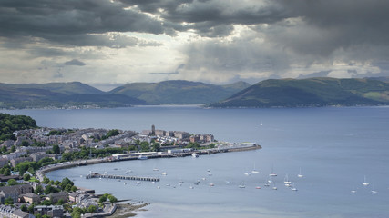 View of Gourock coastal seaside town from Lyle Hill in Greenock during the storm light and dark clouds over mountain  range Scotland UK