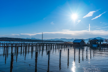 boats and fishermans on a lake at gthe pier on a bright day