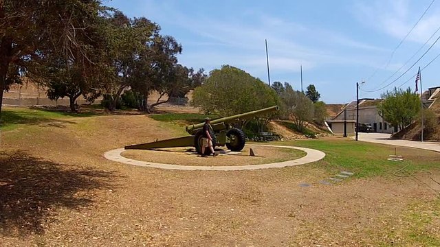 Man Examines WW2 Mobile Artillery Gun