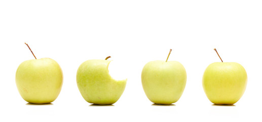 Bitten apple among whole ones