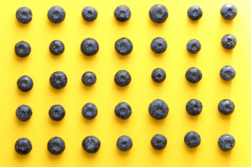 blueberries on a yellow background. summer and vitamins