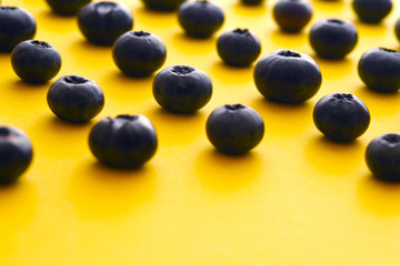 blueberries on a yellow background. summer and vitamins