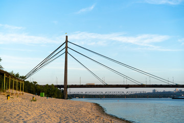 River beach at the sunset with cityscape at the background
