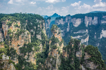 Fototapeta na wymiar Top view of amazing natural quartz sandstone pillars of fantastic shapes among green woods in the Tianzi Mountains Avatar Mountains, the Zhangjiajie National Forest Park, Hunan Province, China.