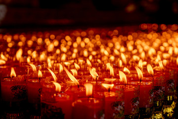Fototapeta na wymiar Close up lit prayer candles for Chinese new year festival in Black Background. 