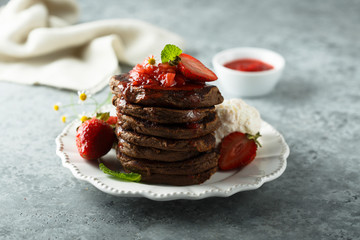 Homemade chocolate pancakes with strawberry sauce