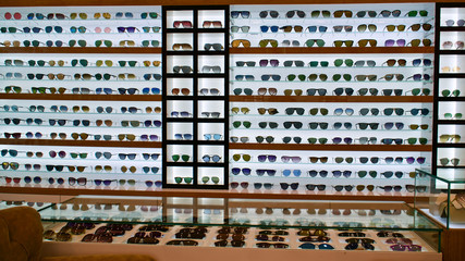 Types of sunglasses, sun glasses on store shelves, optician