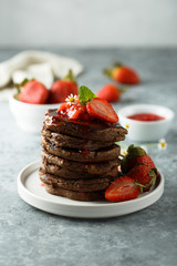 Homemade chocolate pancakes with strawberry sauce