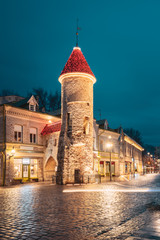 Tallinn, Estonia. Tower Of Viru Gate In Street Lighting At Evening Or Night Illumination. Towers In...