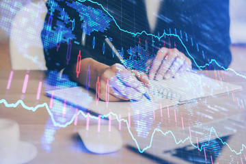 Forex graph on hand taking notes background. Concept of research. Multi exposure