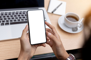 Mockup image blank white screen cell phone.man hand holding texting using mobile on desk at office.background empty space for advertise text.people contact marketing business,technology 