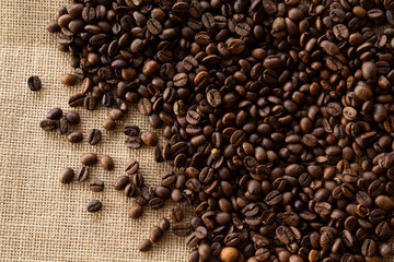 Structured linen background with roasted coffee beans