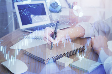 Financial charts displayed on woman's hand taking notes background. Concept of research. Double exposure