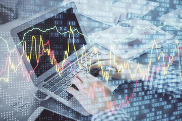 Double exposure of forex graph with man working on computer on background. Concept of market analysis.