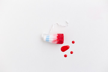 Female swab with drops of red blood on a white background