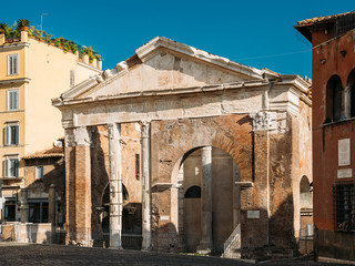 Fototapeta na wymiar Rome, Italy. Facade Of Ancient Structure Portico Of Octavia In Sunny Day