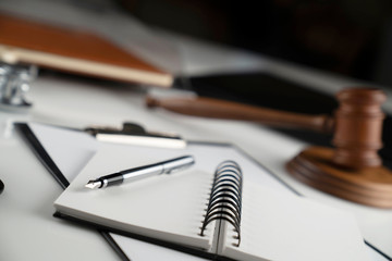 Medical law concept. Gavel, notebook and stethoscope on the white table. Place for text.